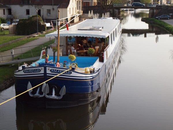 The elite Hotel Barge Amaryllis, one of the ultimate luxury hotel barges in France, moored in Burgundy.