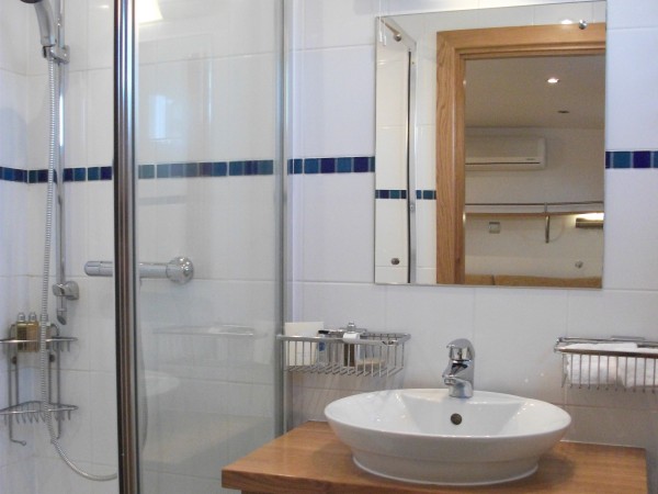 The roomy, modern en suite bathroom on the Apres Tout, has a stand up shower and heated towel rack.