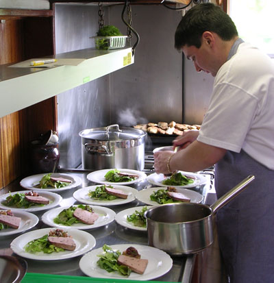 Savoir Faire's chef at work preparing luncheon.