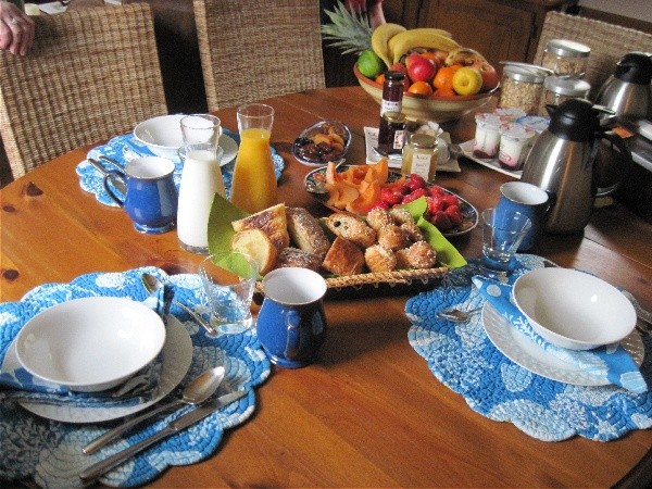 The breakfast table filled with delicious
breads, croissants, fresh fruits and incredible assorted yogurts