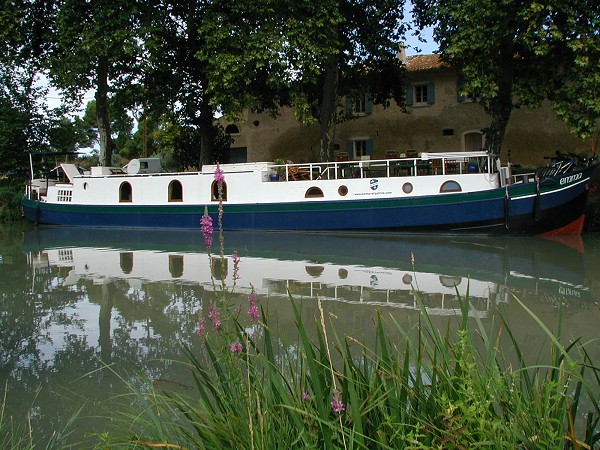The Hotel-Barge Emma, moored on the Canal du Midi between Carcassonne and Beziers on the Canal du Midi region.