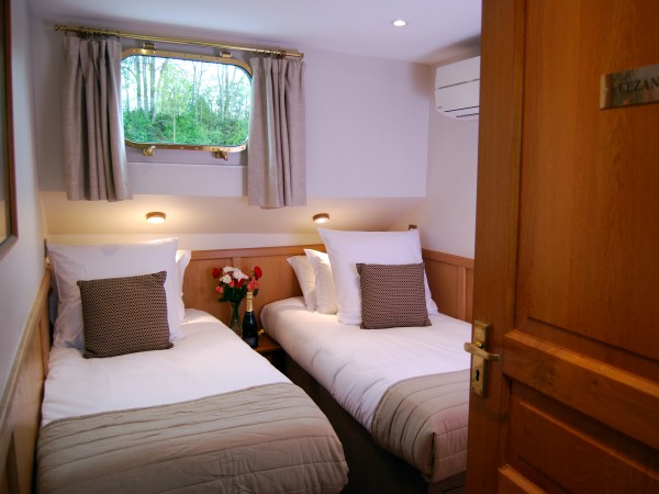 The newly redesigned Cezanne stateroom with
twin beds shown above and queen bed shown below
