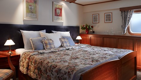 One of the four ultra deluxe cabins aboard La Nouvelle Etoile, featuring twin or queen beds, large baths with twin sinks and very large tiled shower, and DVD/satellite TV.