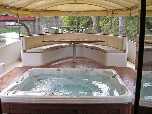 The Roi Soleil's aft deck offers a removable awning, jacuzzi, and wrap around rear seating with cocktail table for refreshments in the afternoon.