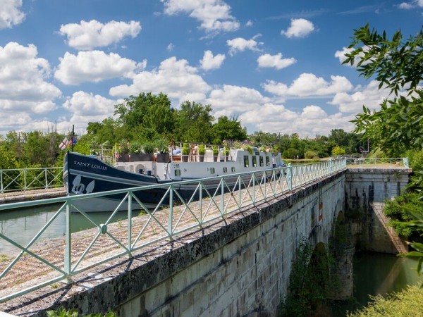 The Saint Louis cruising on an
historic
aqueduct over the River Baise