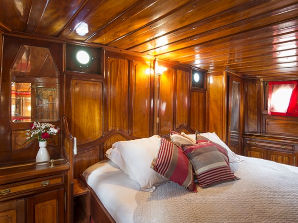 The Captain's cabin offers elegant dark wood and stained
glass