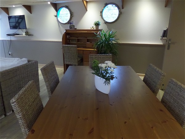 The dining table of the Magnolia, with a writing desk in
the salon,
beyond.