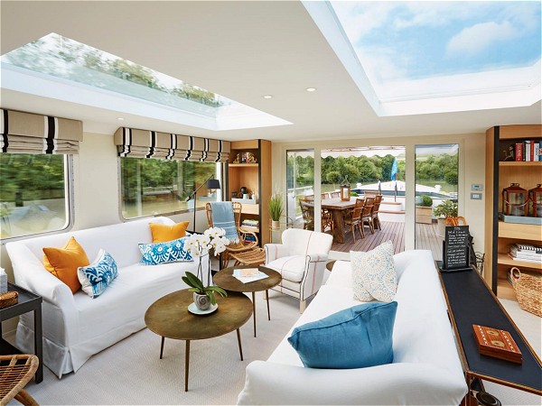The stylish and contemporary salon and dining
room with skylights and large picture windows